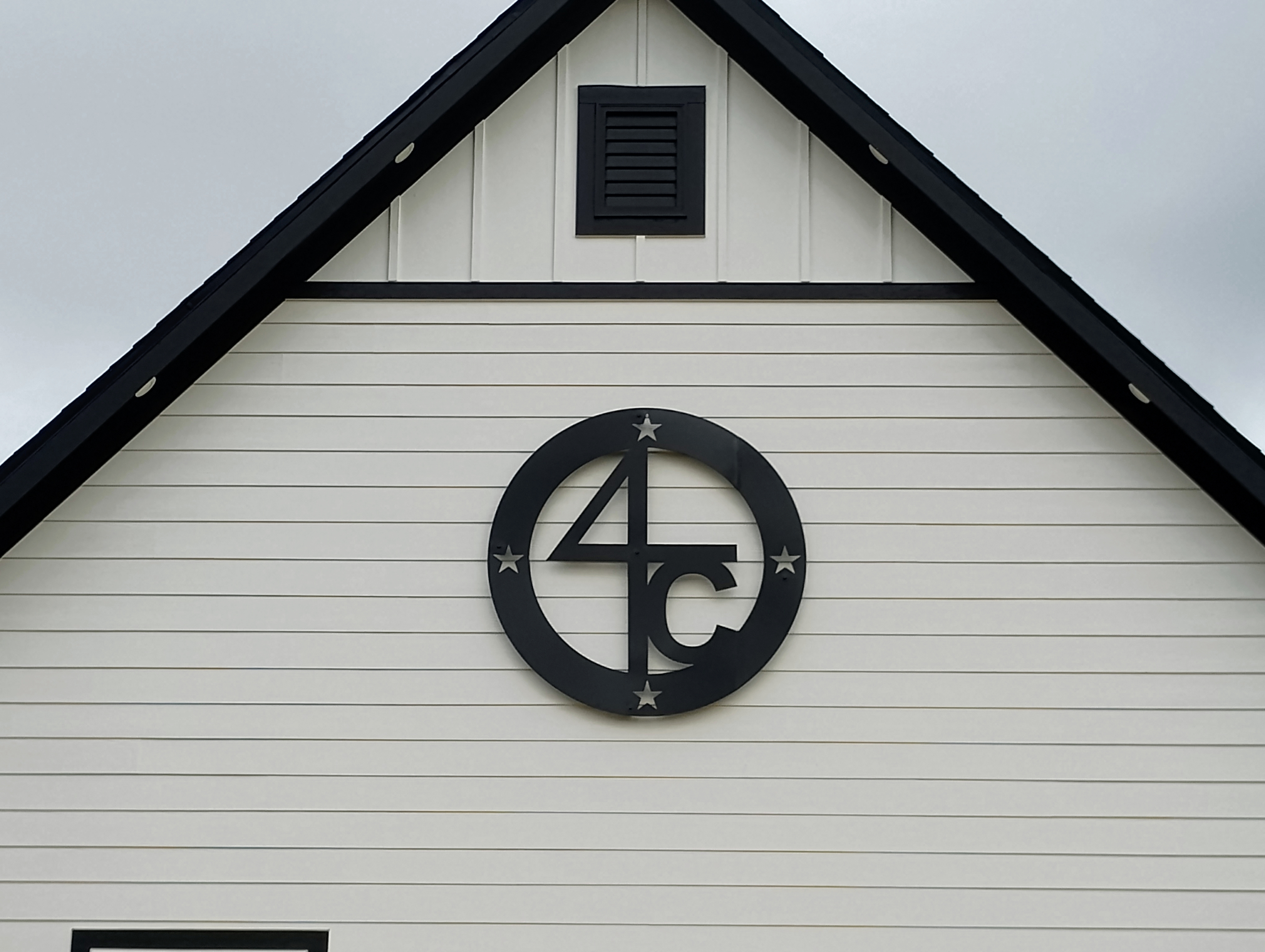 4C monogram sign above house entry