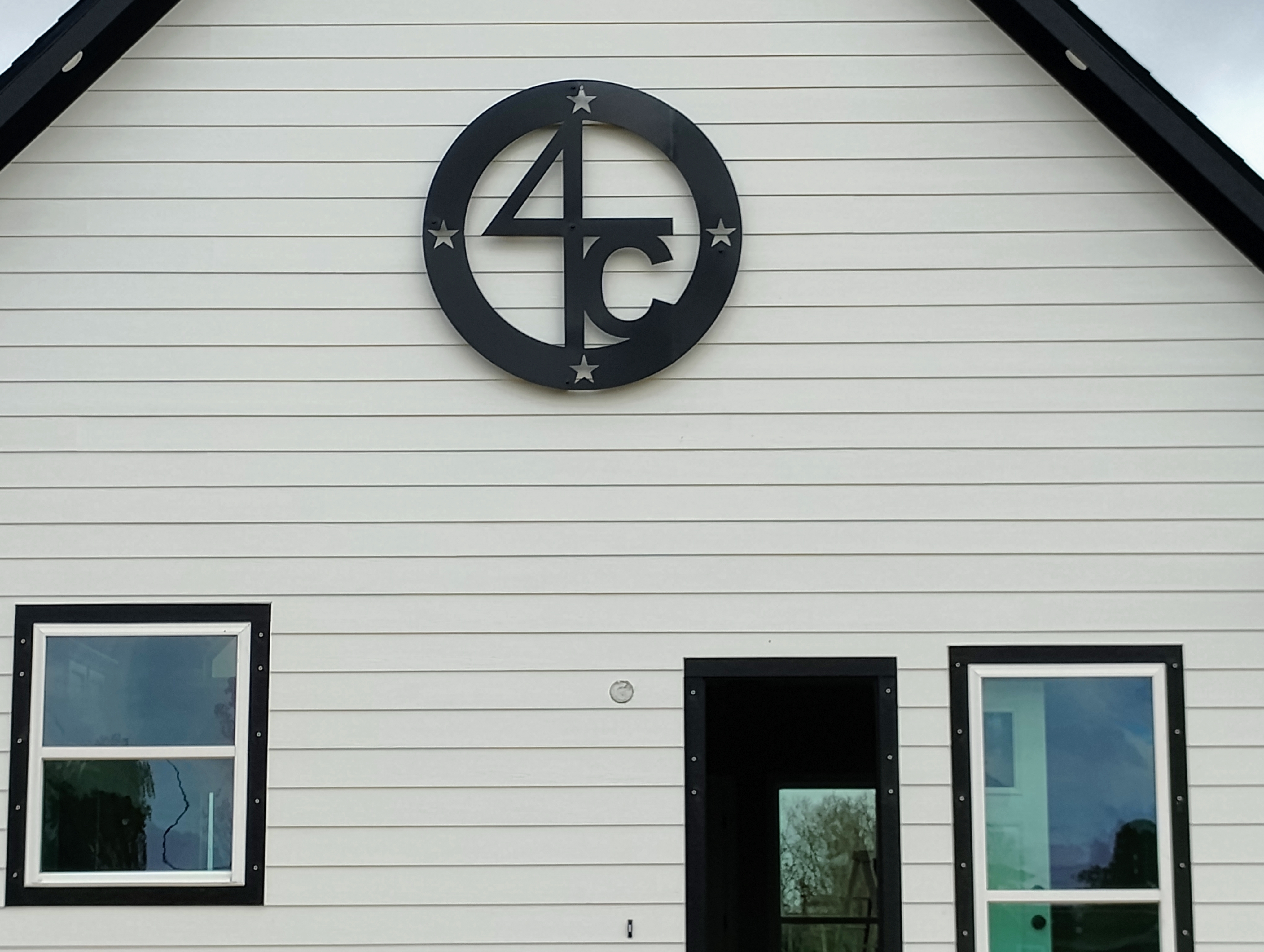 Wide view of 4C monogram sign on house gable