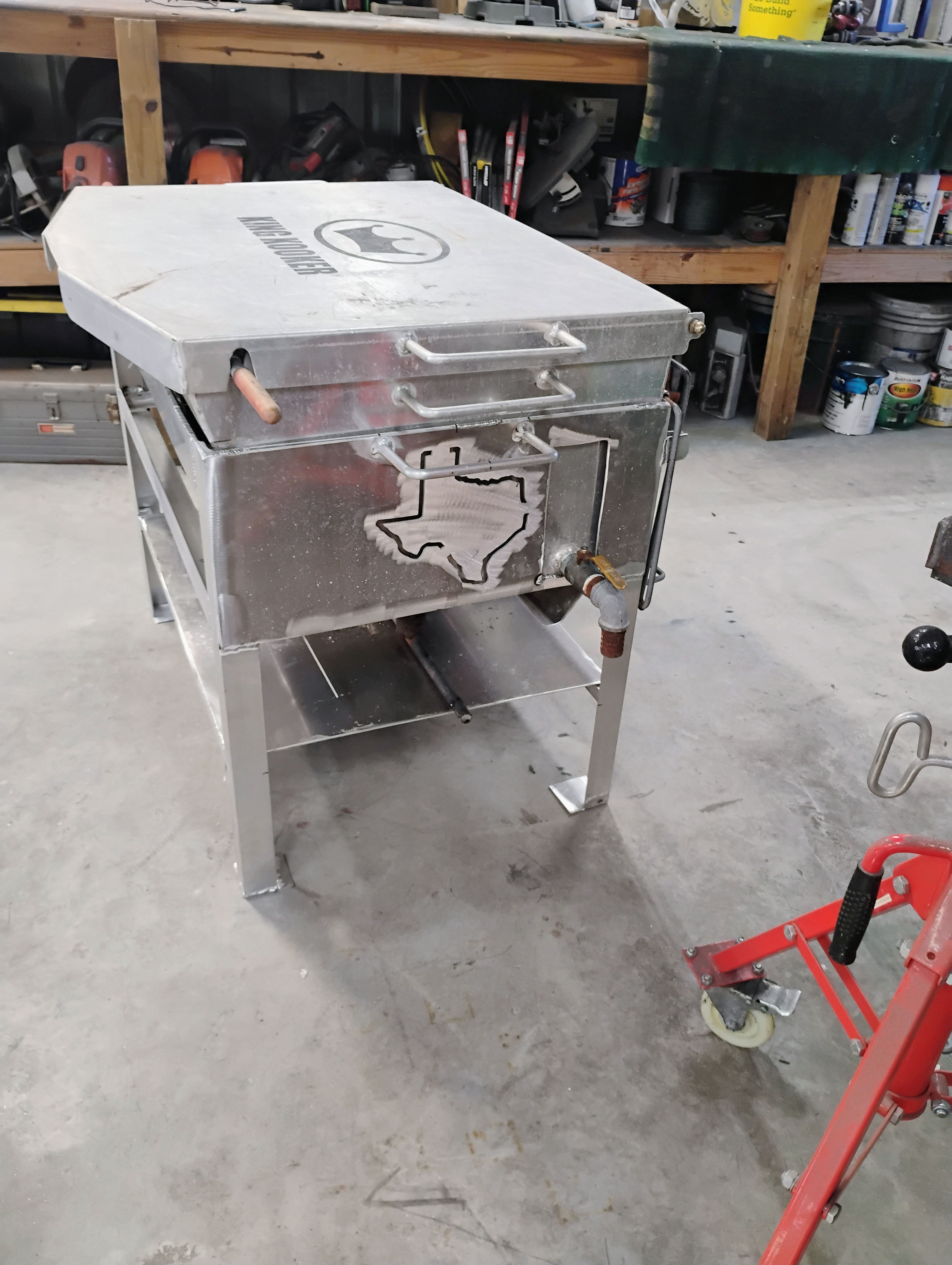 Side view of custom stainless cooker showing Texas cutout and handle details